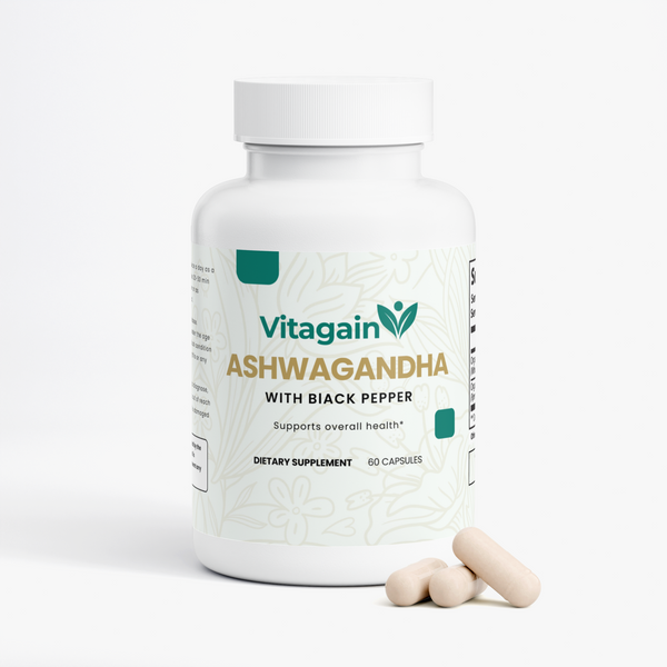 A white plastic bottle of Vitagain Ashwagandha dietary supplement with black pepper, shown on a clean white background with three capsules in front of the bottle.